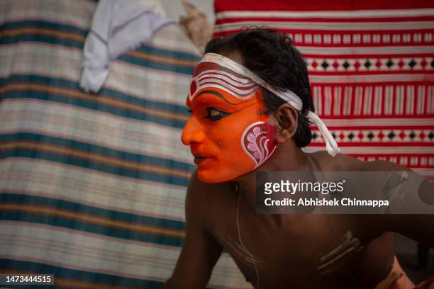 Man waits to change into costume to the likeness of the Hindu deity Sasthappan during the Theyyam ritualistic dance festival on March 13, 2023 in...