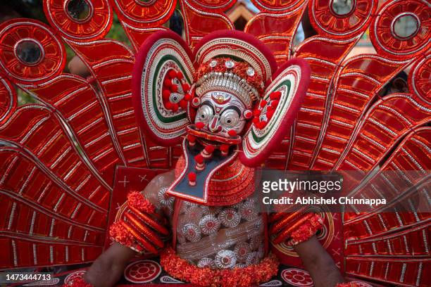 Man dressed in the likeness of the Hindu deity Karimkutty Sasthappan performs during the Theyyam ritualistic dance festival on March 14, 2023 in...