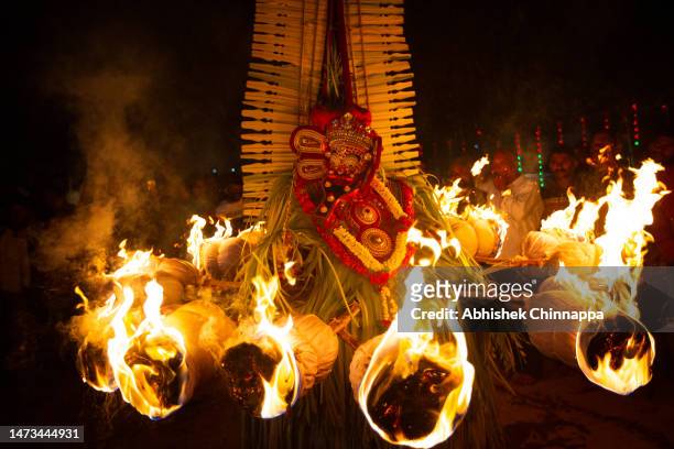 Man dressed in the likeness of the Hindu deity Agni Kandakarnan performs during the Theyyam ritualistic dance festival on March 14, 2023 in...