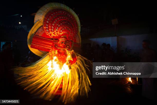 Man dressed in the likeness of the Hindu deity Bhagavathy performs during the Theyyam ritualistic dance festival on March 14, 2023 in Somwarpet,...