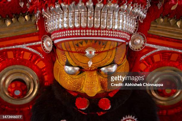 Man dressed in the likeness of the Hindu deity Thiruvappan performs during the Theyyam ritualistic dance festival on March 14, 2023 in Somwarpet,...