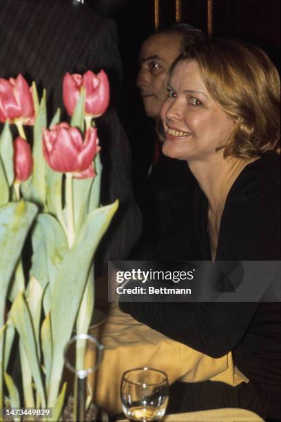 Close-up of actress Ellen Burstyn sitting near a pot of tulips at a party in New York on March 13th, 1975.