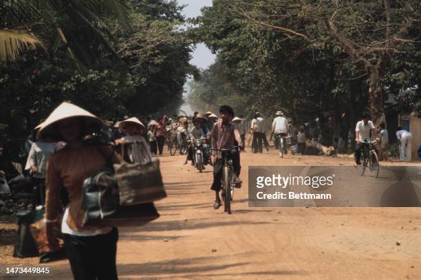 Refugees fleeing the Communist advance are travelling along a road in Dau Tieng District, 35 miles north of Saigon, South Vietnam, on March 19th,...