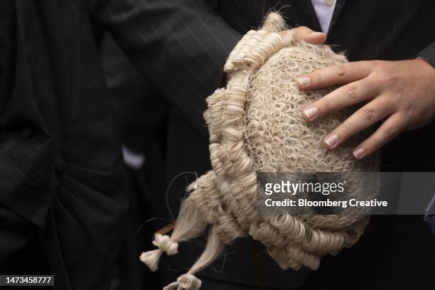 a lawyer holding a wig - uk judge stock pictures, royalty-free photos & images
