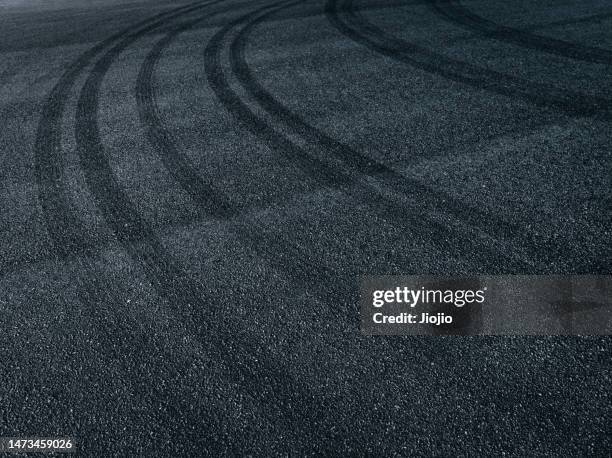 racing track covered with tire marks - motor racing track stock pictures, royalty-free photos & images