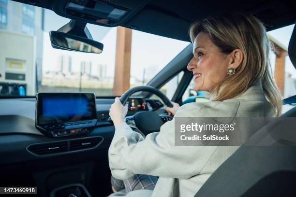 businesswoman driving to work - driving stock pictures, royalty-free photos & images