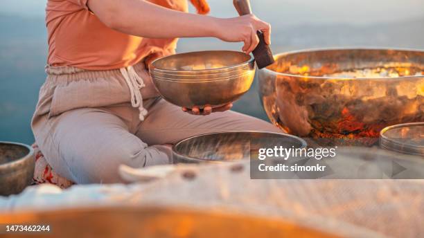woman holding ring gong - music therapy stock pictures, royalty-free photos & images