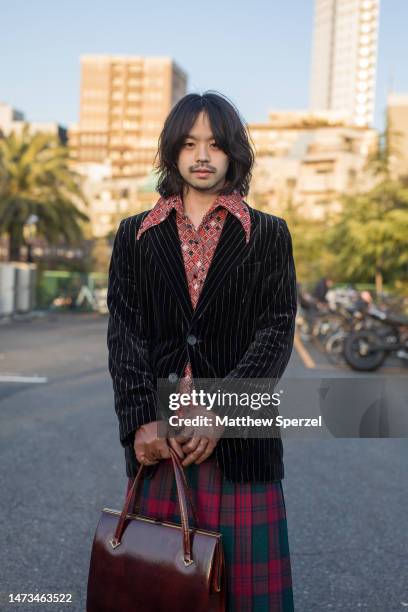 Guest is seen wearing vintage outfit with plaid skirt attending UCF in Minamiaoyama at Rakuten Fashion Week TOKYO 2023 A/W on March 14, 2023 in...