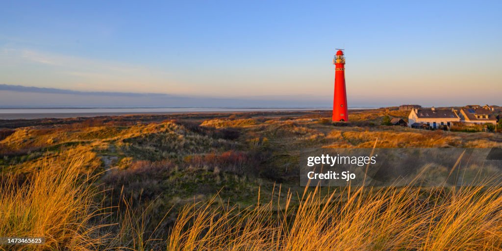 Schiermonnikoog panoramic view in the dunes with the lighthouse during sunset