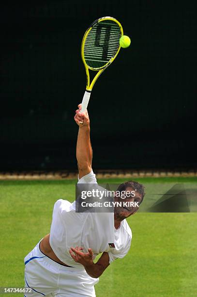 Britain's James Ward serves during his second round men's singles match against US player Mardy Fish on day four of the 2012 Wimbledon Championships...