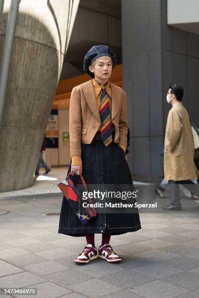 Guest is seen wearing vintage striped tie, denim beret and Nike sneakers attending Seivson in Shibuya at Rakuten Fashion Week TOKYO 2023 A/W on March...