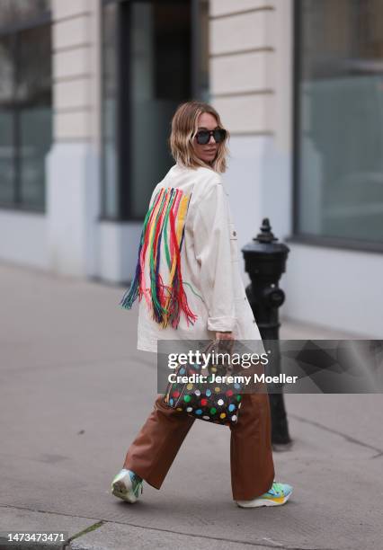 Karin Teigl seen wearing Andy Wolf brown sunglasses with blue lenses, Gestuz brown leather pants, Palm Angels x Missoni cream white denim jacket with...