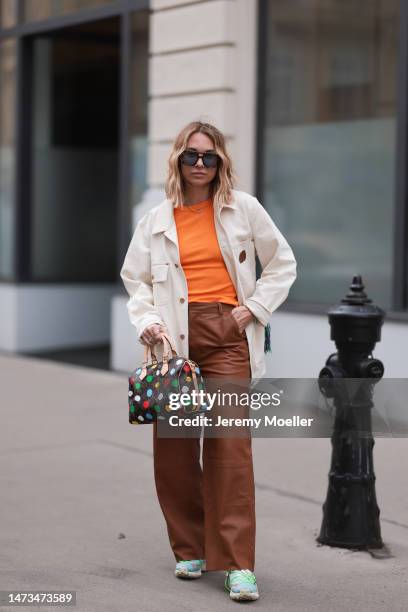 Karin Teigl seen wearing Andy Wolf brown sunglasses with blue lenses, Gestuz brown leather pants, Palm Angels x Missoni cream white denim jacket with...