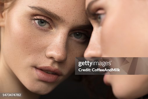 Beautiful emotional woman with natural make-up looking at the mirror Beautiful emotional woman with natural make-up looking at the mirror