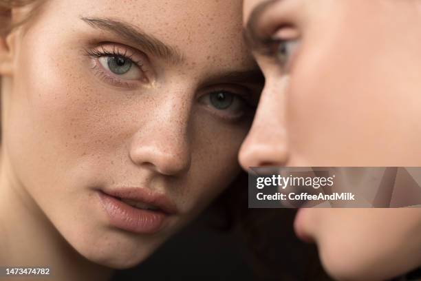 beautiful emotional woman with natural make-up looking at the mirror - beauty mirror imagens e fotografias de stock