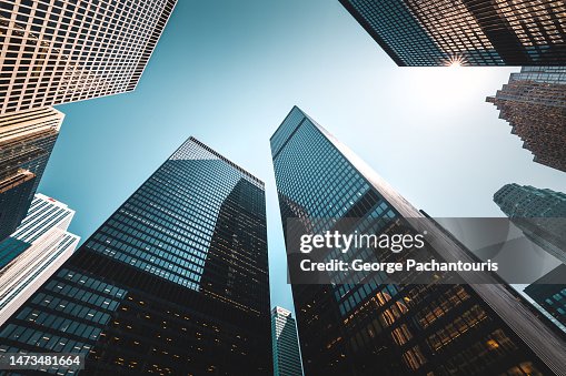 Low angle view of sunlight and skyscrapers in the financial district Low angle view of sunlight and skyscrapers in the financial district