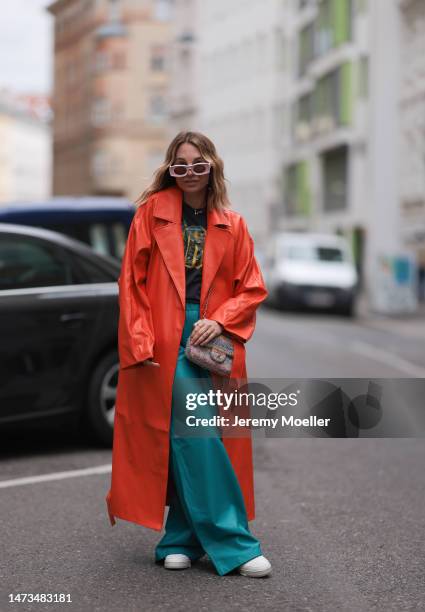 Karin Teigl seen wearing Loewe light pink sunglasses, gold / silver jewelry, Samsoe Samsoe turquoise / blue leather pants, Chanel colorful fabric...