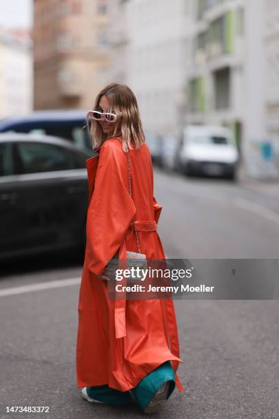 Karin Teigl seen wearing Loewe light pink sunglasses, gold / silver jewelry, Samsoe Samsoe turquoise / blue leather pants, Chanel colorful fabric...