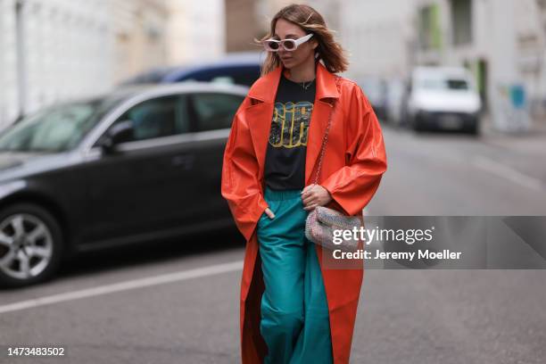 Karin Teigl seen wearing Loewe light pink sunglasses, gold / silver jewelry, Samsoe Samsoe turquoise / blue leather pants, Chanel colorful fabric...