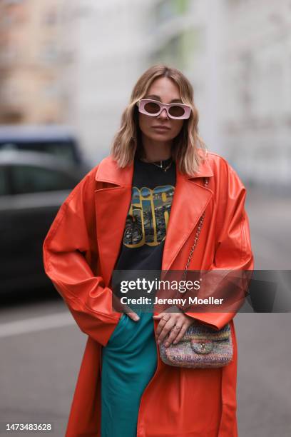 Karin Teigl seen wearing Loewe light pink sunglasses, gold / silver jewelry, Samsoe Samsoe turquoise / blue leather pants, Chanel colorful fabric...