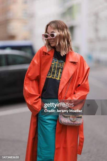 Karin Teigl seen wearing Loewe light pink sunglasses, gold / silver jewelry, Samsoe Samsoe turquoise / blue leather pants, Chanel colorful fabric...