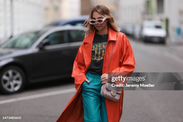 Karin Teigl seen wearing Loewe light pink sunglasses, gold / silver jewelry, Samsoe Samsoe turquoise / blue leather pants, Chanel colorful fabric...