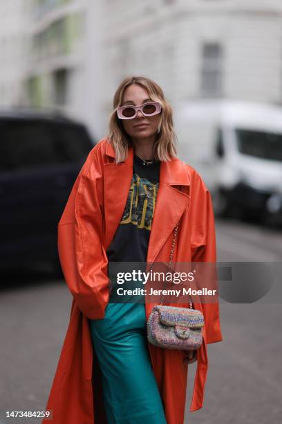 Karin Teigl seen wearing Loewe light pink sunglasses, gold / silver jewelry, Samsoe Samsoe turquoise / blue leather pants, Chanel colorful fabric...