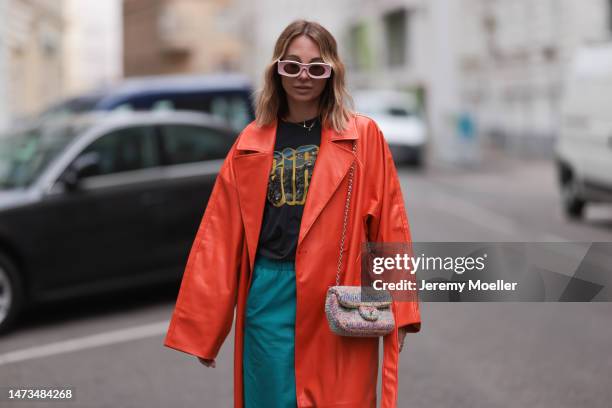 Karin Teigl seen wearing Loewe light pink sunglasses, gold / silver jewelry, Samsoe Samsoe turquoise / blue leather pants, Chanel colorful fabric...