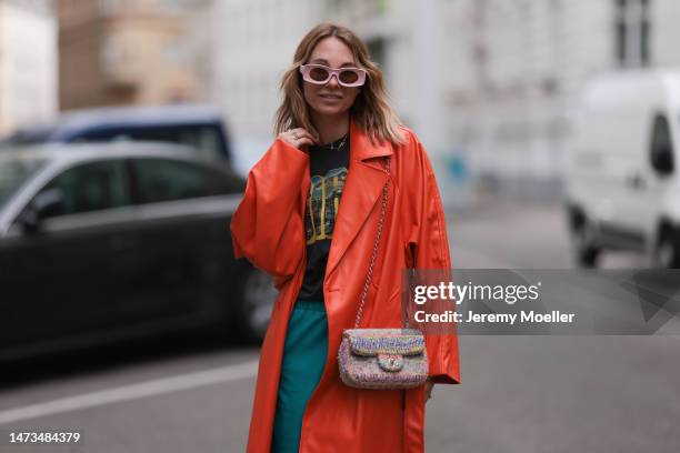 Karin Teigl seen wearing Loewe light pink sunglasses, gold / silver jewelry, Samsoe Samsoe turquoise / blue leather pants, Chanel colorful fabric...