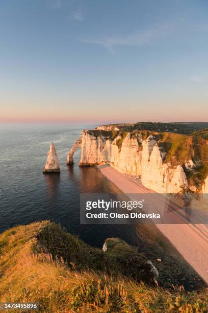 view on the natural arch porte d'aval at sunset, ètretat, normandy, france - bathing in sunset stock pictures, royalty-free photos & images