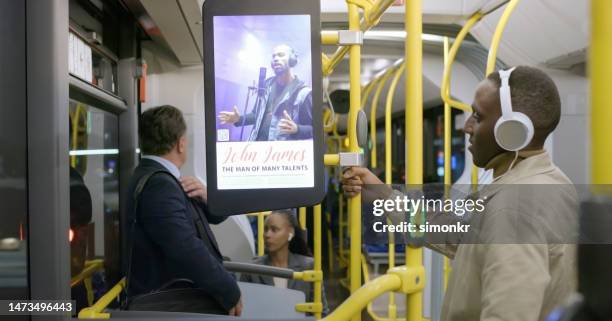 passengers standing in bus - bus advertising stockfoto's en -beelden