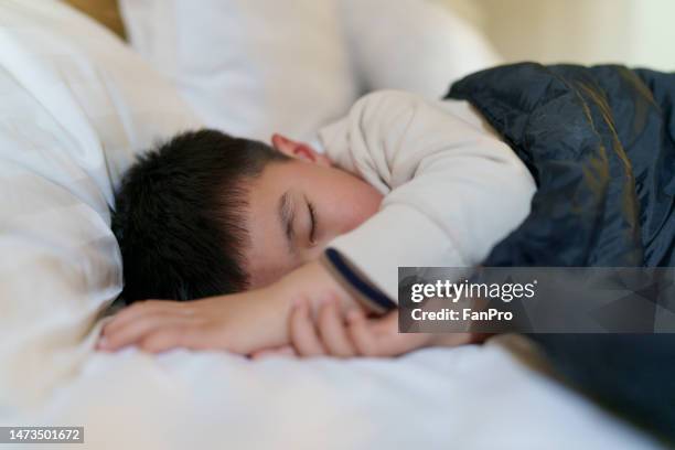 a little boy was tired and fell asleep in the hotel - child sleeping stock pictures, royalty-free photos & images