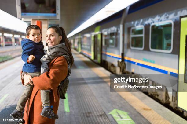 mother and son waiting on a train station - railway station platform stock pictures, royalty-free photos & images