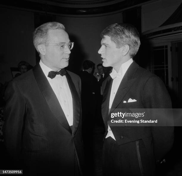 American-born film producer Edward Danziger and British singer Adam Faith attend the London premiere of the film 'The Facts of Life' at the Odeon...