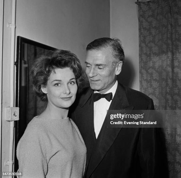 British actor Sir Laurence Olivier poses with Scottish actress Adrienne Corri at the opening night of the play 'The Shifting Heart' at the Duke of...