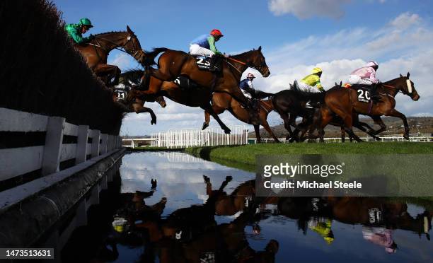 Runners take the water jump during the Ultima Handicap Chase during day one of the Cheltenham Festival 2023 at Cheltenham Racecourse on March 14,...