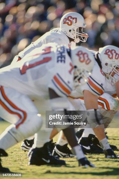 Tone Jones, Quarterback for the Oklahoma State Cowboys calls the play at the line of scrimmage during the NCAA Big 8 Conference college football game...