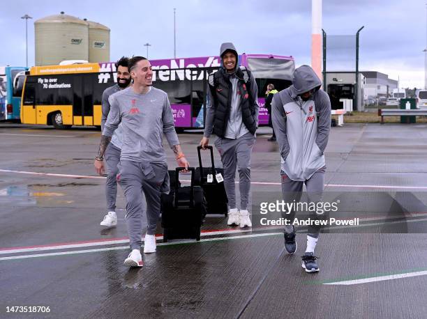 Kostas Tsimikas, Mohamed Salah, Fabinho and Naby Keita of Liverpool boarding a plane at Liverpool John Lennon Airport on March 14, 2023 in Liverpool,...