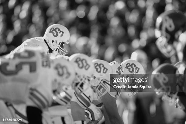 This image has been converted to black and white), Tone Jones, Quarterback for the Oklahoma State Cowboys calls the play at the line of scrimmage...