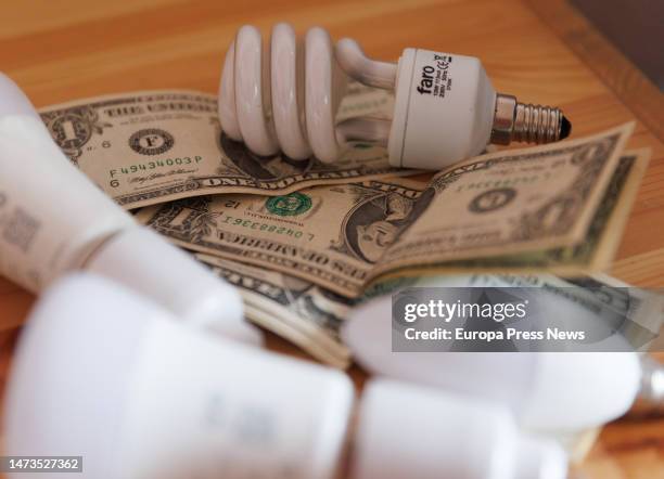 Several light bulbs and banknotes on a table on March 14 in Madrid, Spain. The Consumer Price Index has risen by 0.9% in February compared to the...