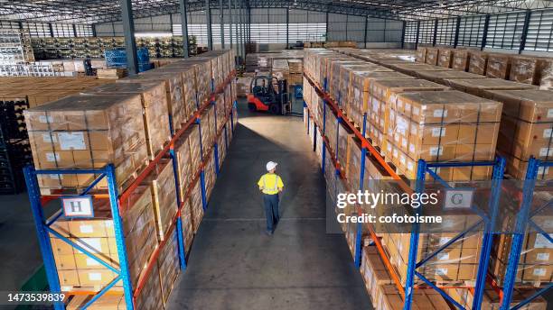 luftaufnahme von lagerarbeitern, die im auslieferungslager arbeiten und gehen - logistik stock-fotos und bilder