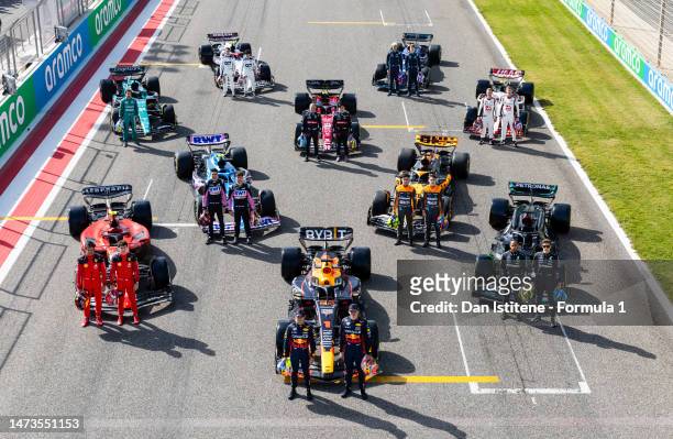 The F1 drivers pose for a photo on the grid with their cars during day one of F1 Testing at Bahrain International Circuit on February 23, 2023 in...