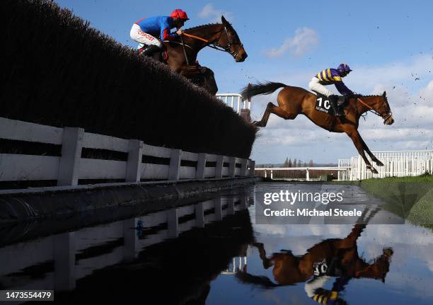 Derek Fox riding Corach Rambler takes the water jump on his way to winning the Ultima Handicap Chase during day one of the Cheltenham Festival 2023...