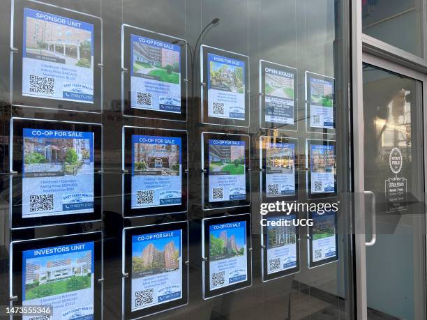 Digital listings sign in window of real estate office, Queens, New York.