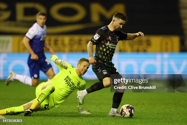 Sean Maguire of Coventry City is put under pressure by Ben Amos of Wigan Athletic during the Sky Bet Championship between Wigan Athletic and Coventry...