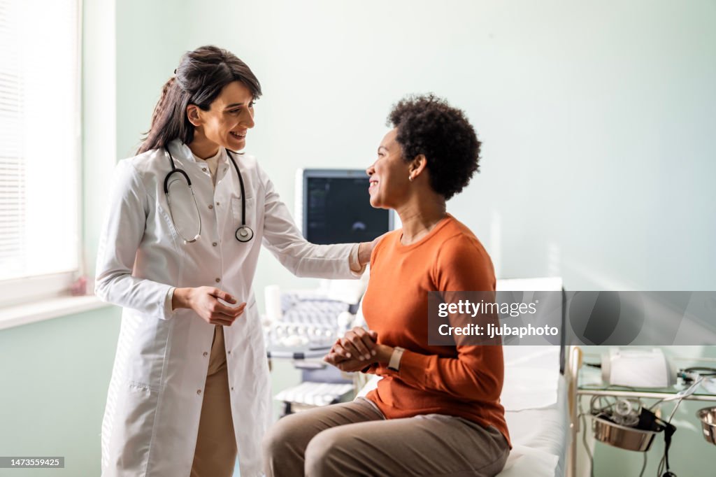 Female medical practitioner reassuring a patient