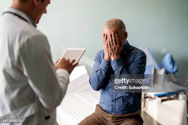 doctor treating male patient suffering with depression - 50 year old male patient stock pictures, royalty-free photos & images