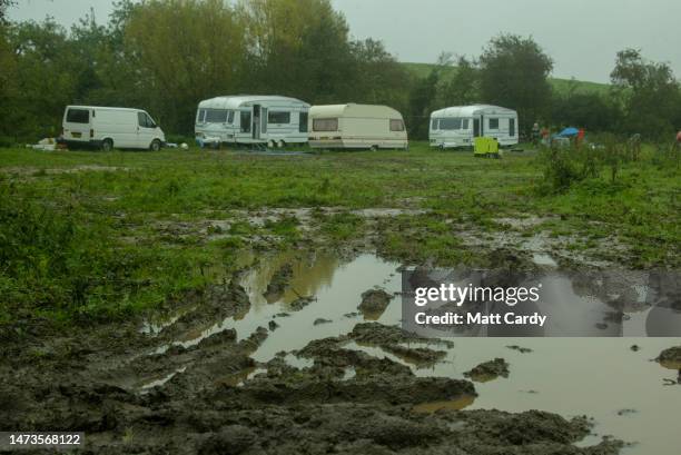 Puddle of water has formed at the entrance to a field containing caravans belonging to gypsies who have set up an illegal camp near Pershore on May...