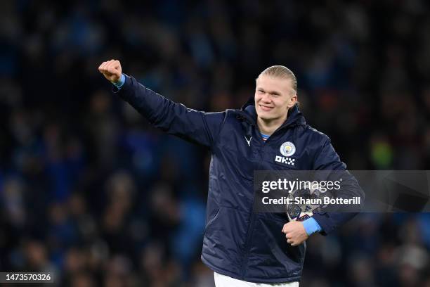 Erling Haaland of Manchester City celebrates victory with their match ball after scoring a hat-trick in the UEFA Champions League round of 16 leg two...