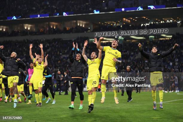 Hakan Calhanoglu and Lautaro Martinez of FC Internazionale celebrate their progression to the Quarter-Final of the UEFA Champions League following...